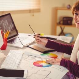 Graphic designer working at desk in office