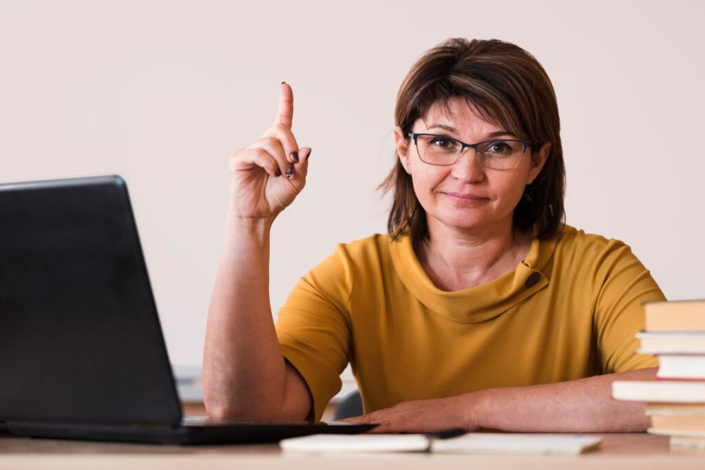 female teacher with laptop pointing