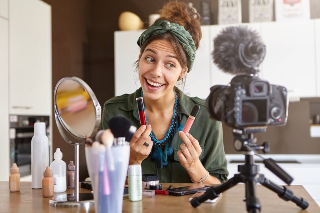 female vlogger filming makeup video