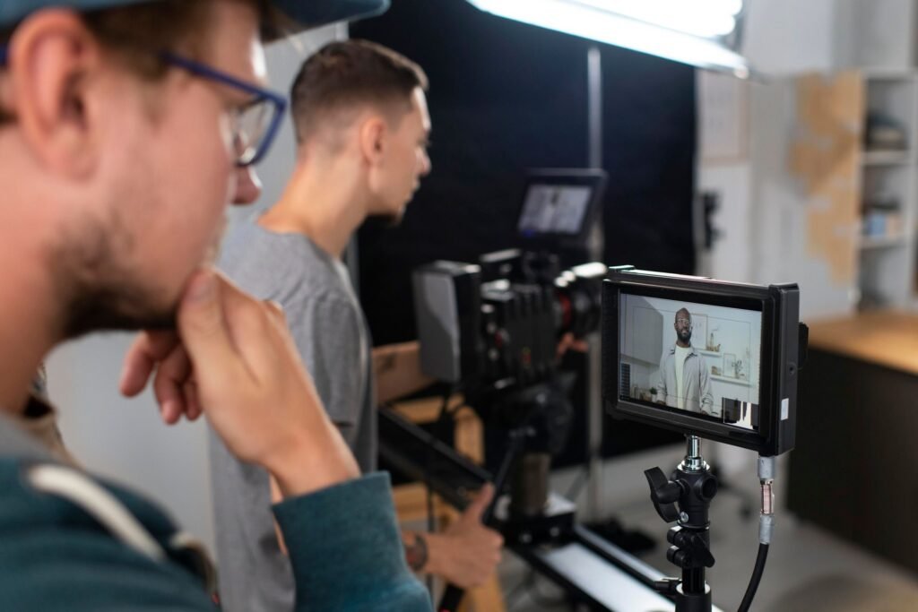 man filming with professional