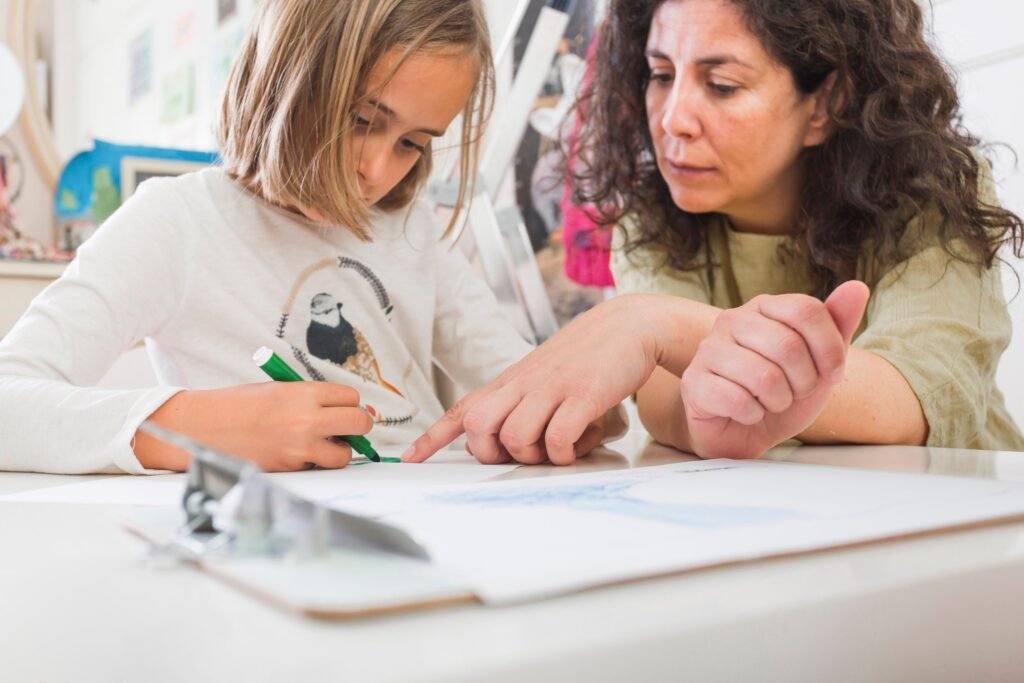 mother helping girl with drawing