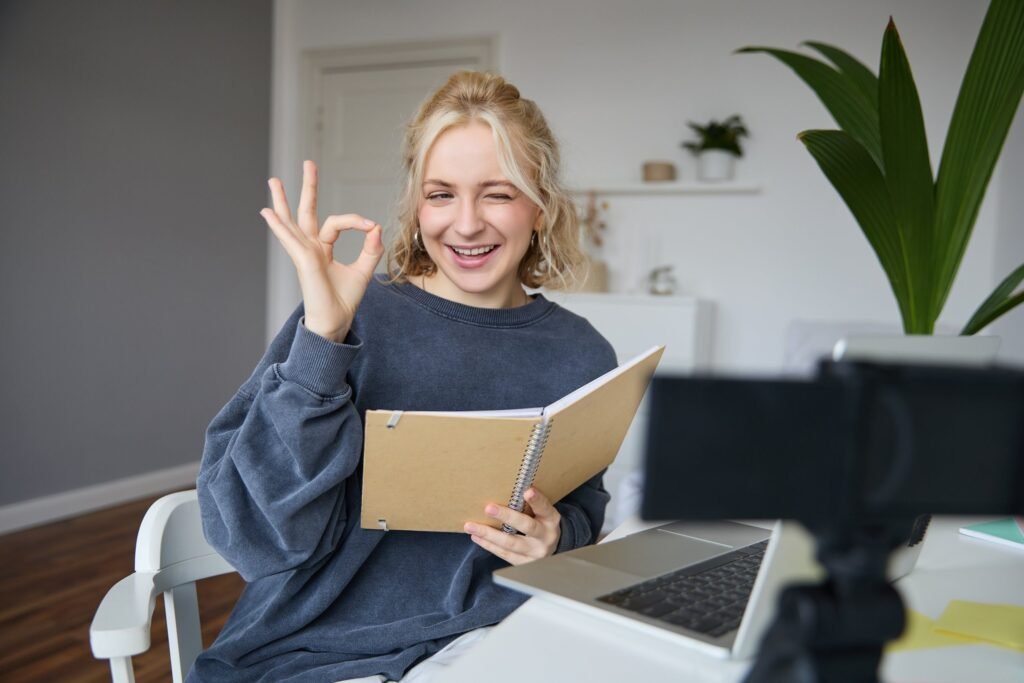 portrait cute blond girl with notebook hands
