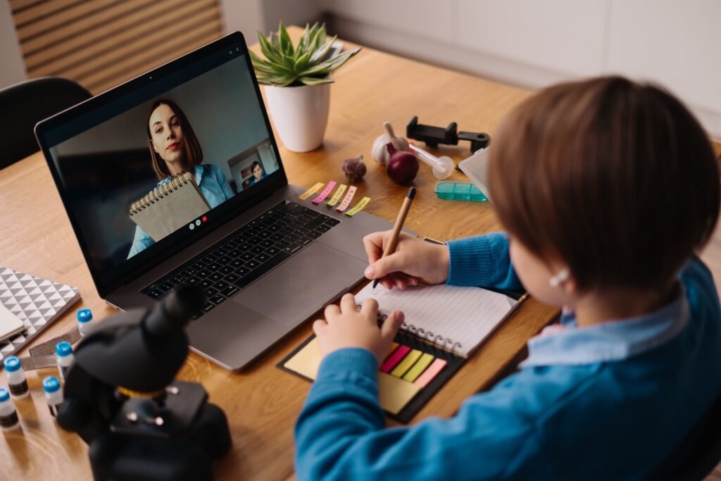 preteen boy uses laptop